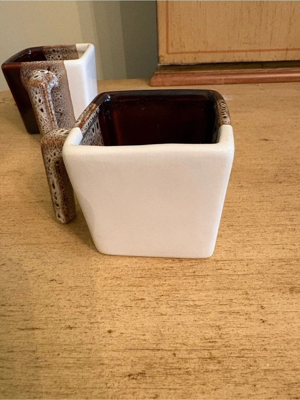 Pier 1 Imports tricolor stoneware square espresso mugs in brown, white, and tan.